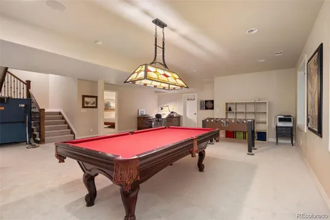 a bedroom with a bed and painting on the wall