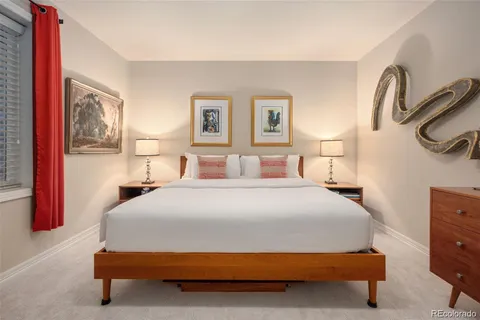 a view of a patio with table and chairs potted plants and large tree