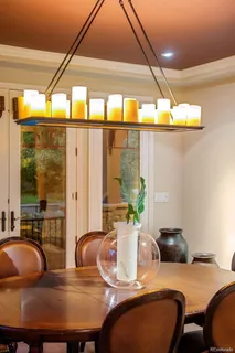 a dining room with furniture and a large window