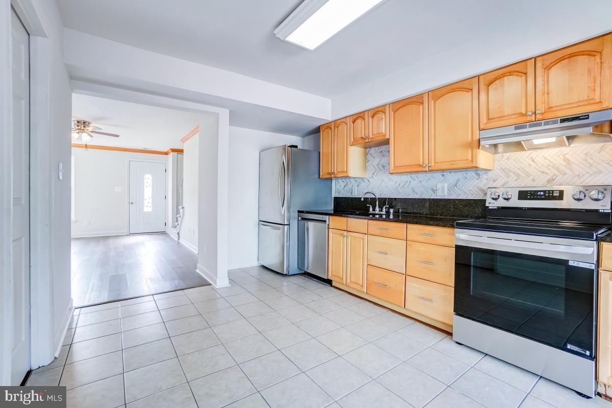 1111 Providence Court Frederick, MD 21703 - Photo 11 of 30 a kitchen with granite countertop a stove sink and cabinets