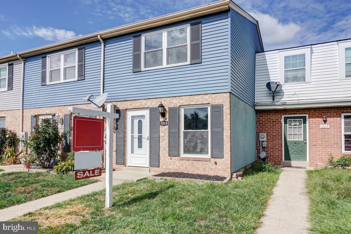 1111 Providence Court Frederick, MD 21703 - Photo 2 of 30 a front view of a house with a yard