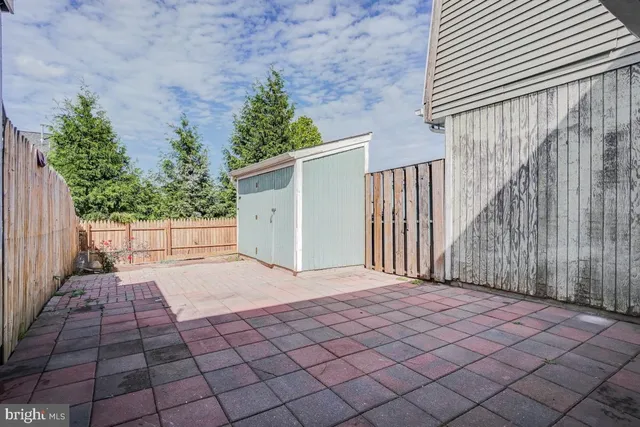 a view of backyard with tub and trees in the background