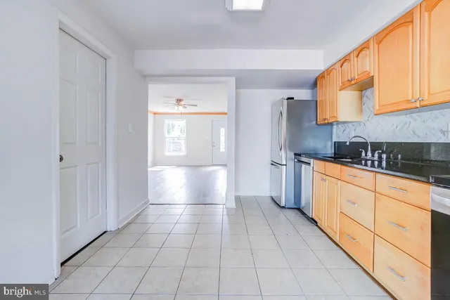 a large white kitchen with cabinets