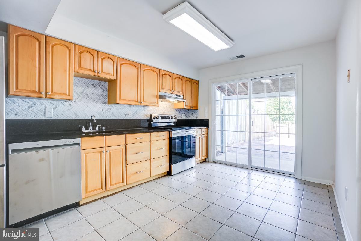 1111 Providence Court Frederick, MD 21703 - Photo 9 of 30 a kitchen with stainless steel appliances granite countertop a stove a sink and a microwave