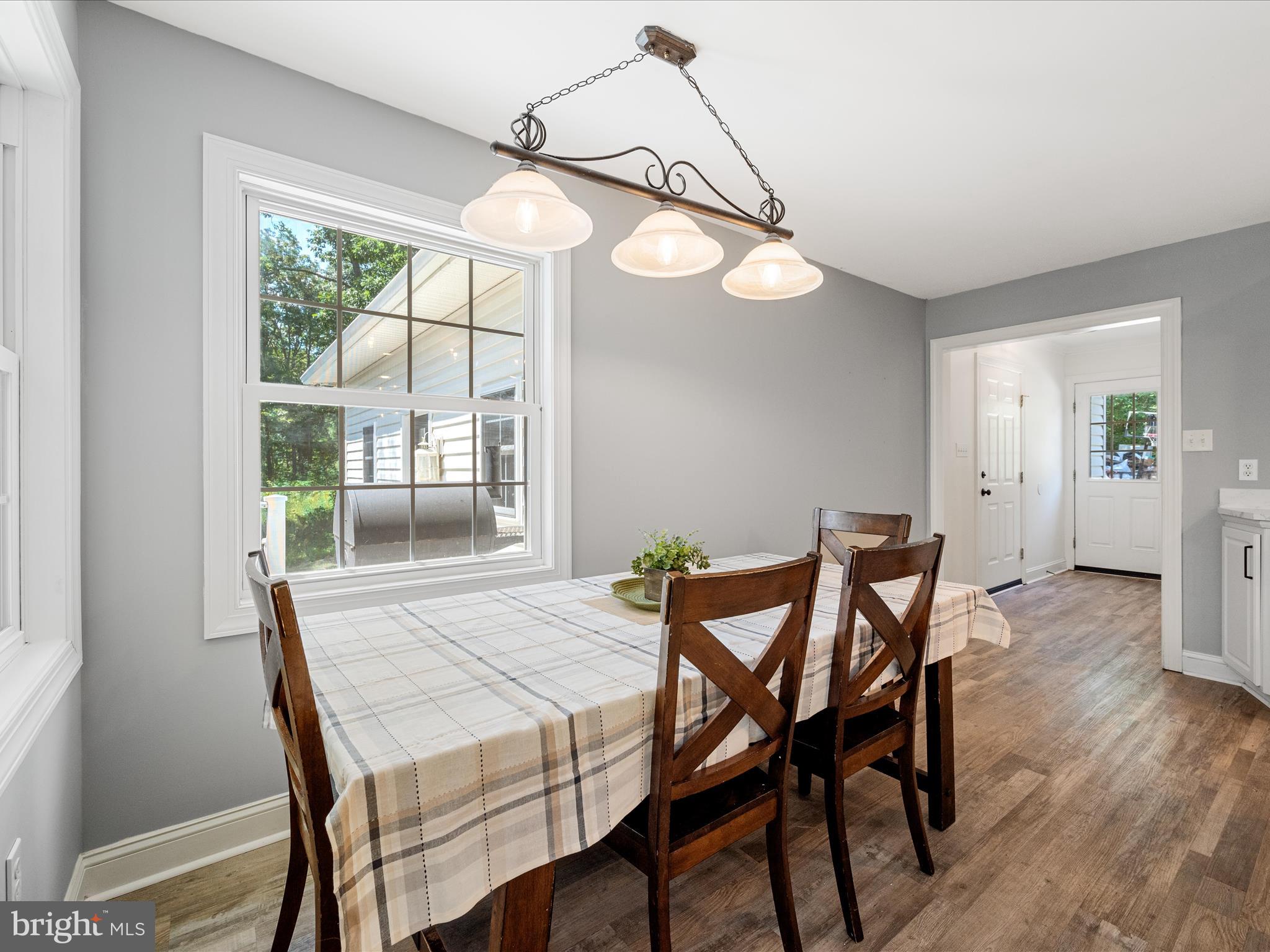 2358 Cave Ridge Road Mount Jackson, VA 22842 - Photo 11 of 59 a view of a dining room with furniture wooden floor and a chandelier