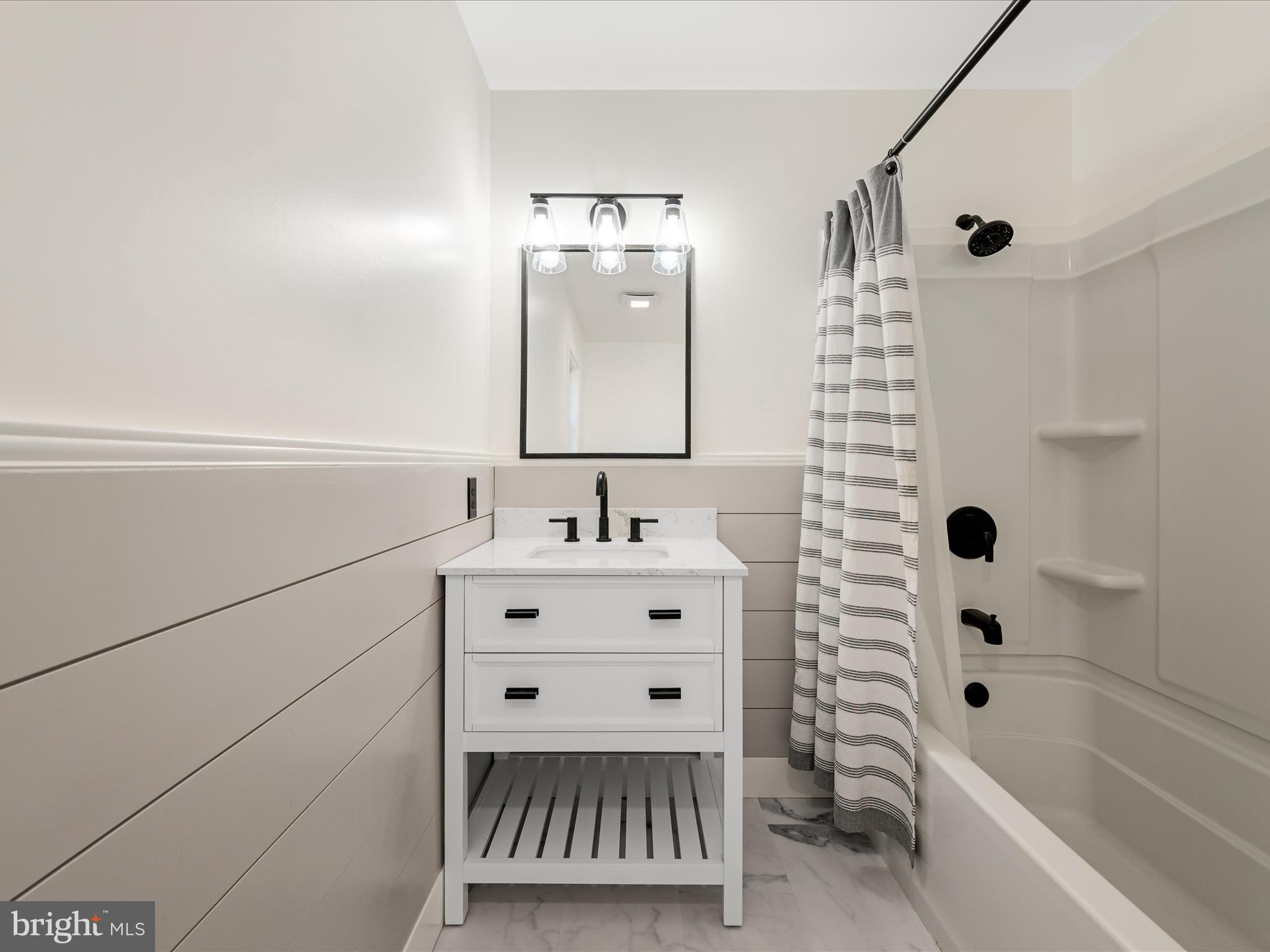2358 Cave Ridge Road Mount Jackson, VA 22842 - Photo 28 of 59 a bathroom with a sink mirror and a bathtub