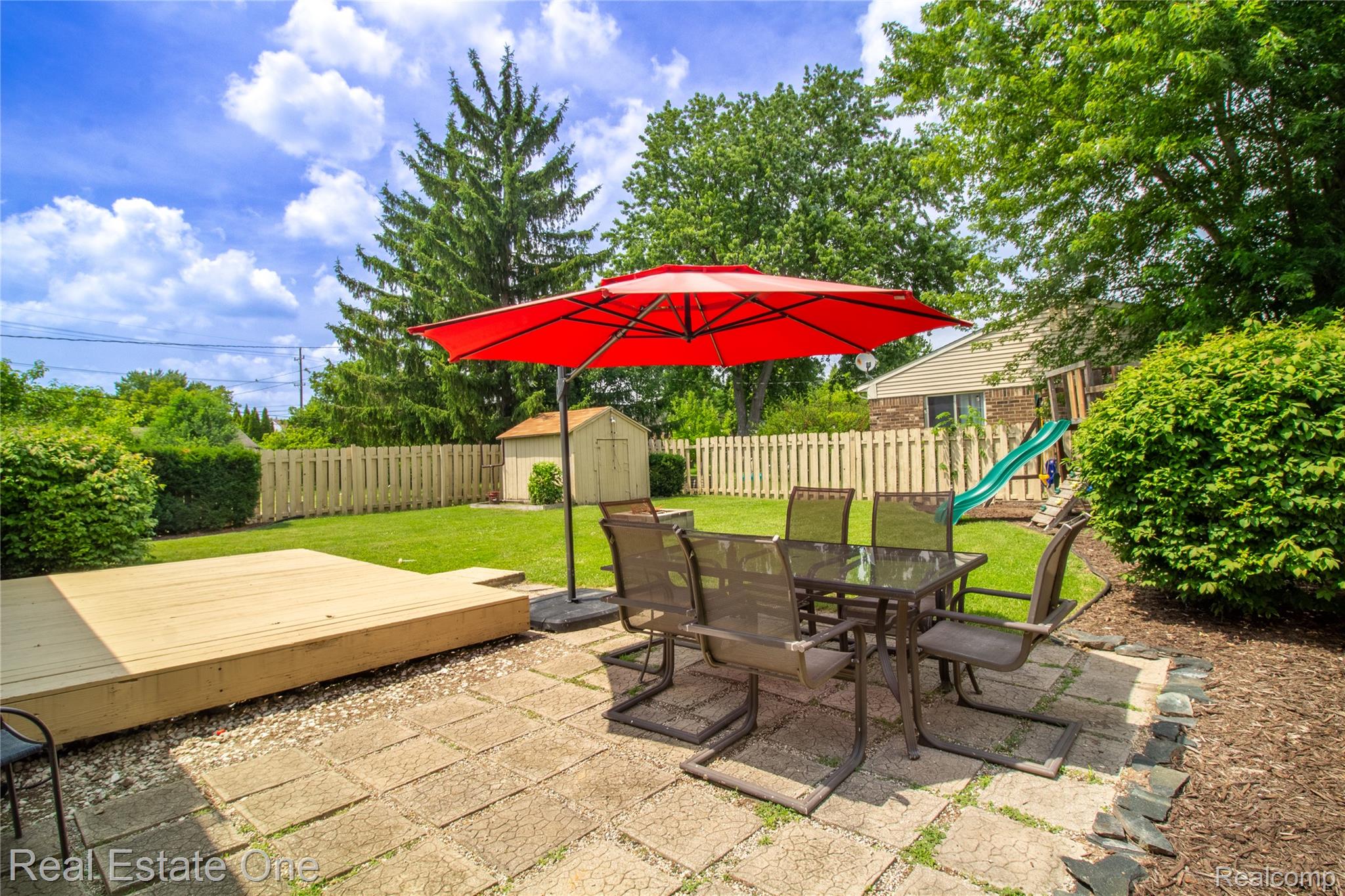 44220 Saltz Road Canton, MI 48187 - Photo 19 of 31 Spacious backyard featuring a paver patio, a raised wood deck, and a picket fence