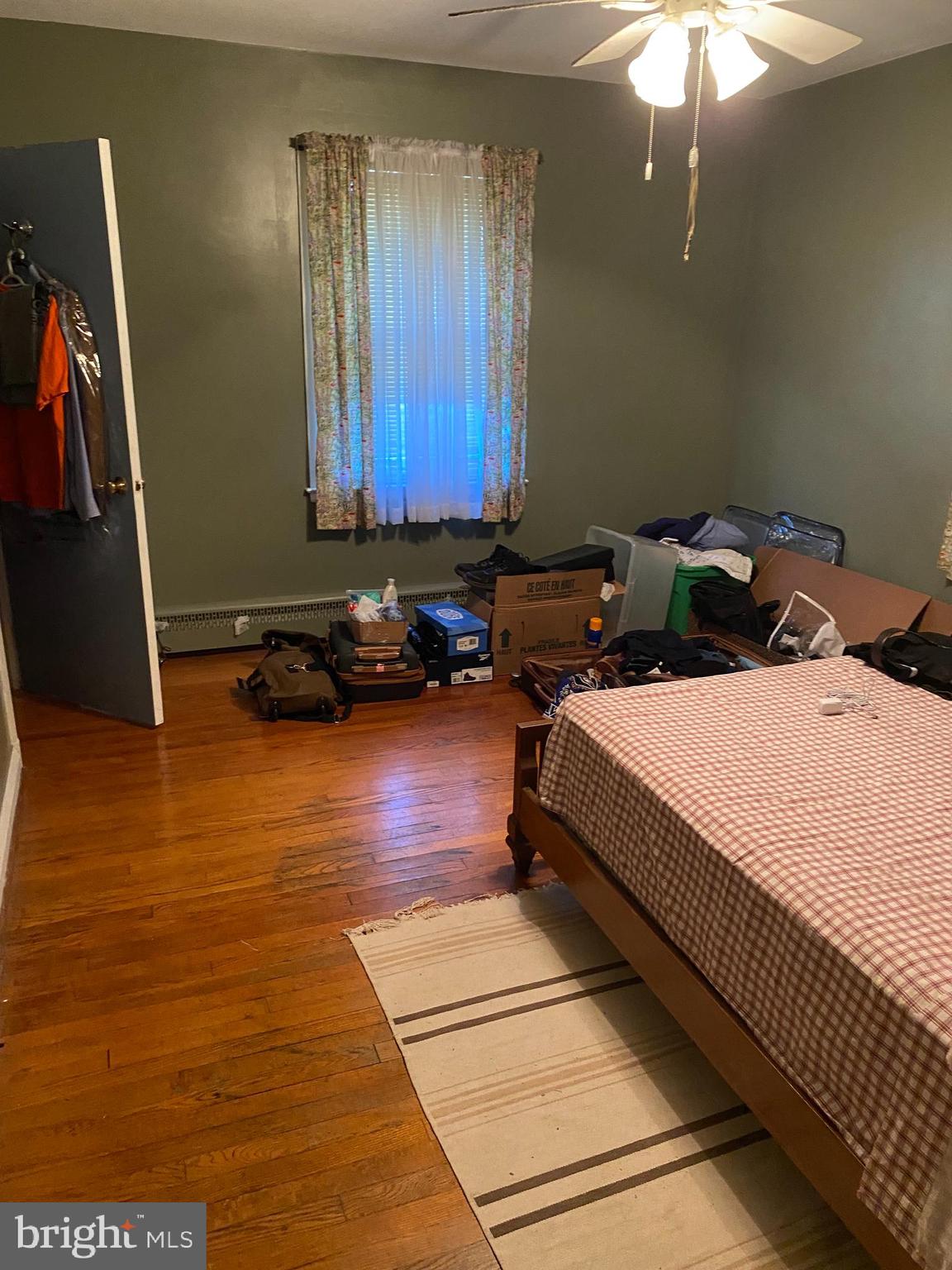 8305 Windsor Mill Road Baltimore, MD 21244 - Photo 9 of 15 a bed sitting in a bedroom next to a window