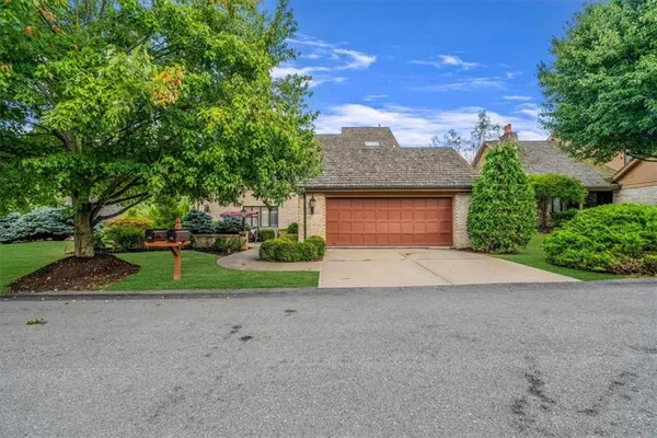 a front view of a house with a yard and a garage