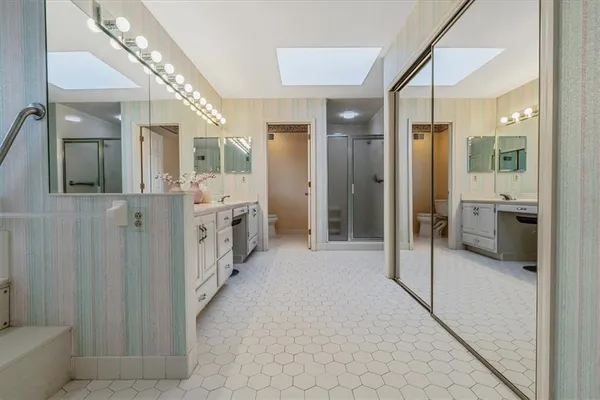 a bathroom with a glass shower door and a sink