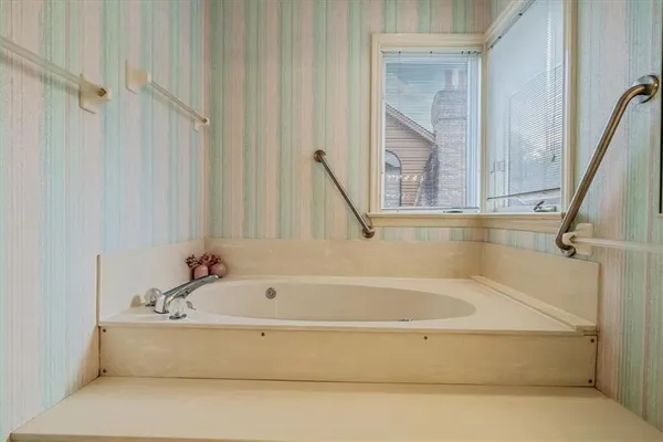 a white bath tub sitting next to a window