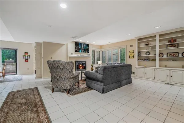 a living room with furniture and a book shelf