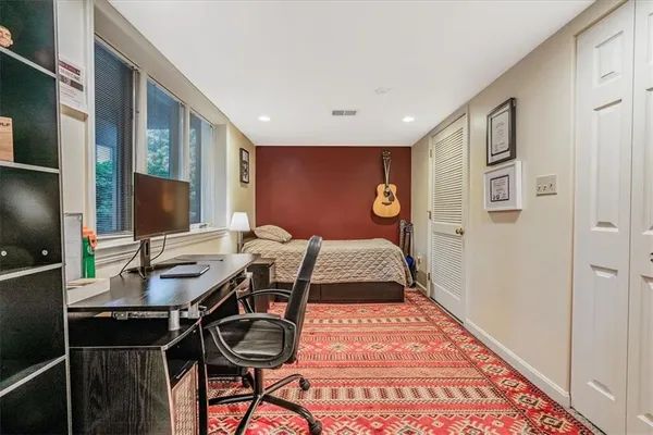a bedroom with a bed and a desk