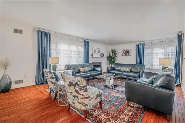 a living room with furniture and wooden floor