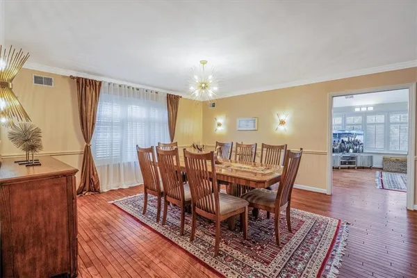 a view of a dining room with furniture and wooden floor