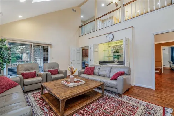 a living room with furniture a rug and a large window