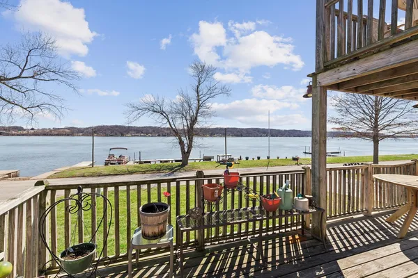 a view of balcony with chairs and wooden floor