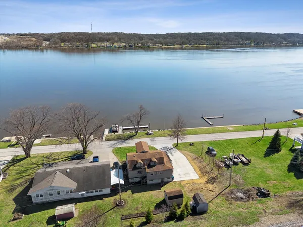 a view of a lake with a table and chairs