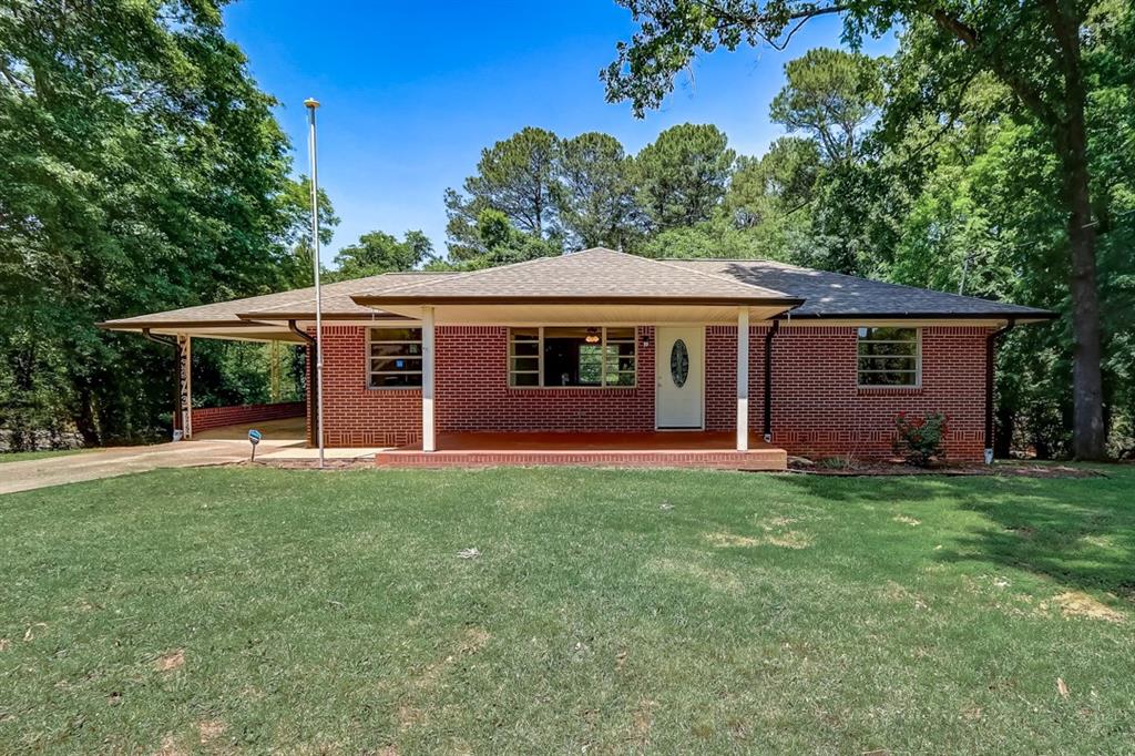 19 Cooper Lake Road Southwest Mableton, GA 30126 - Photo 1 of 1 front view of a house with a garden