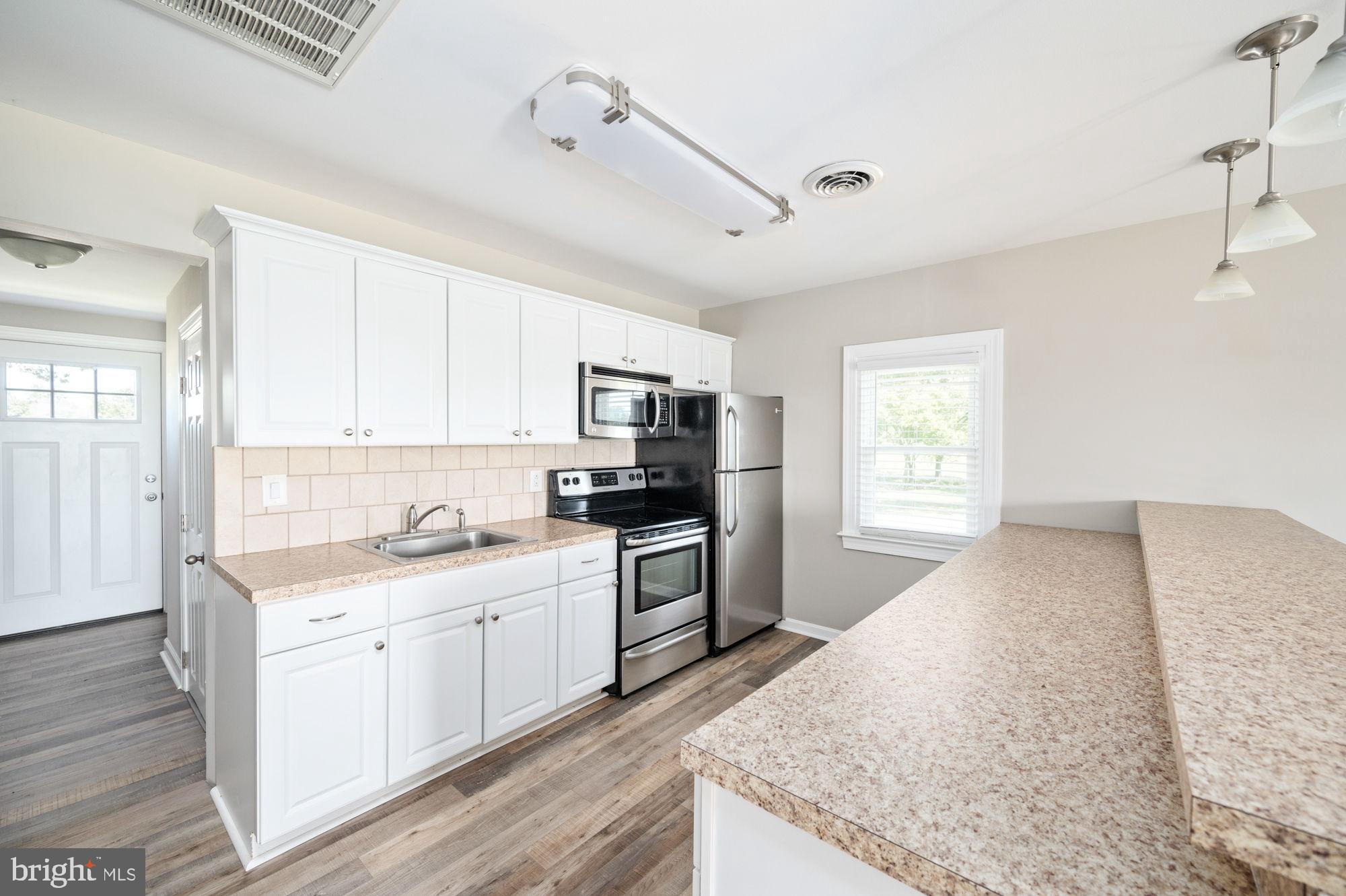 161 Forest Lane Road Fredericksburg, VA 22405 - Photo 14 of 99 a kitchen with a sink stove top oven and refrigerator