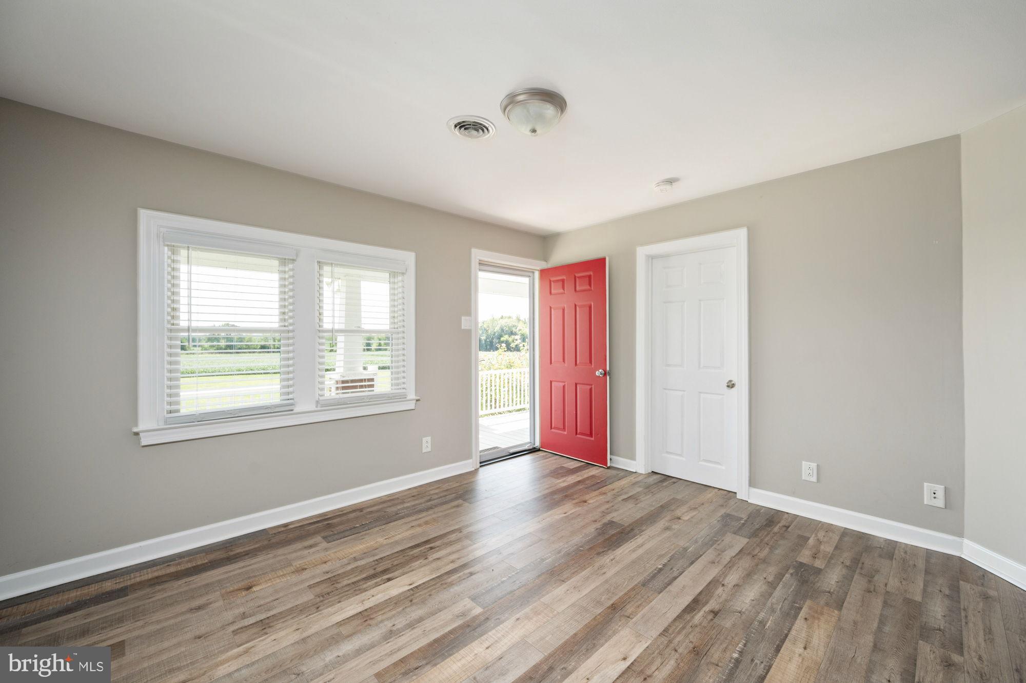 161 Forest Lane Road Fredericksburg, VA 22405 - Photo 18 of 99 a view of an empty room with wooden floor and a window