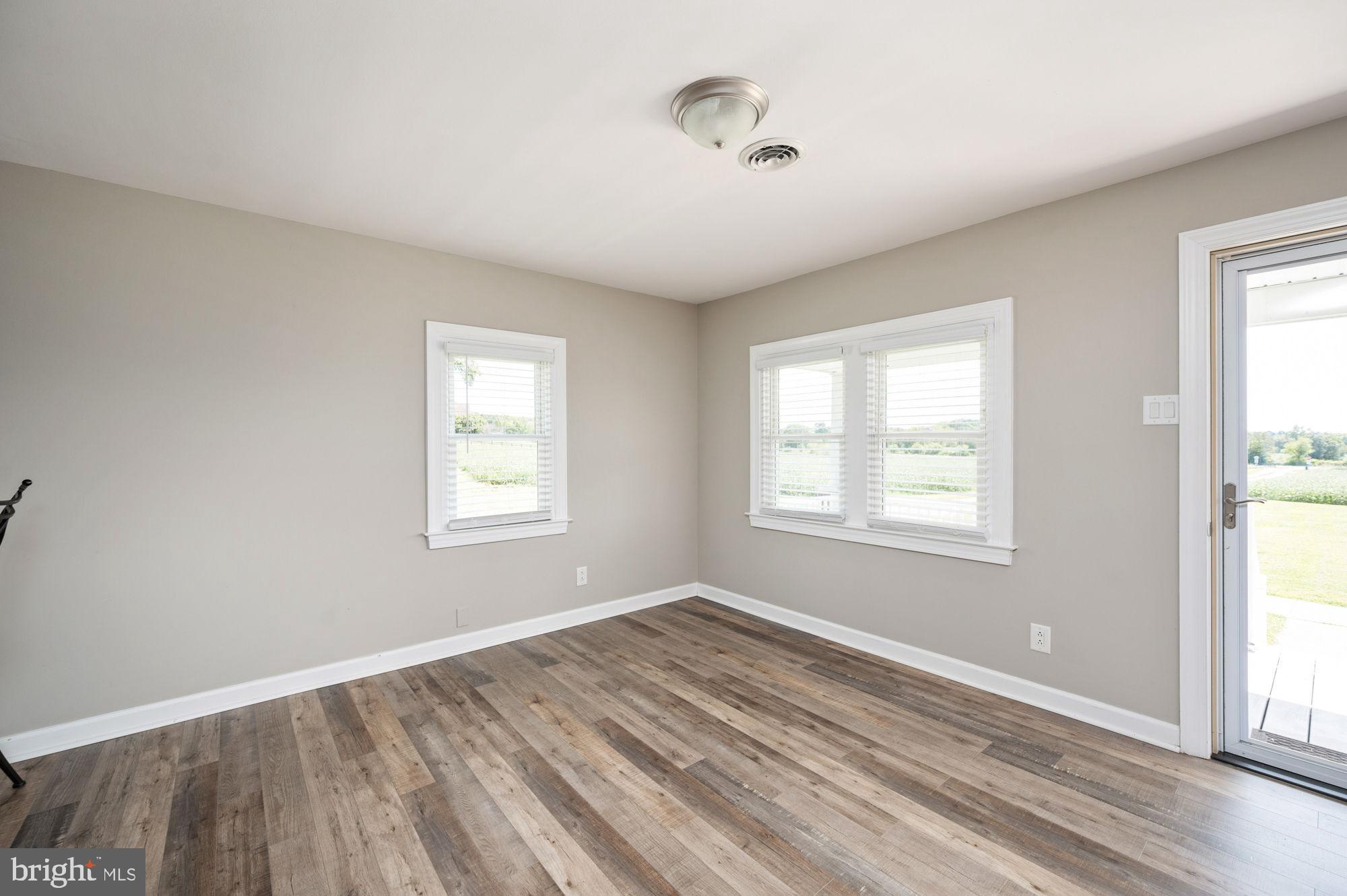 161 Forest Lane Road Fredericksburg, VA 22405 - Photo 21 of 99 a view of an empty room with wooden floor and a window