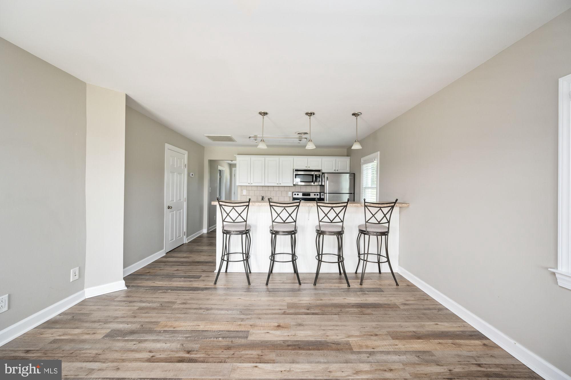 161 Forest Lane Road Fredericksburg, VA 22405 - Photo 24 of 99 a view of a kitchen with dining room and wooden floor