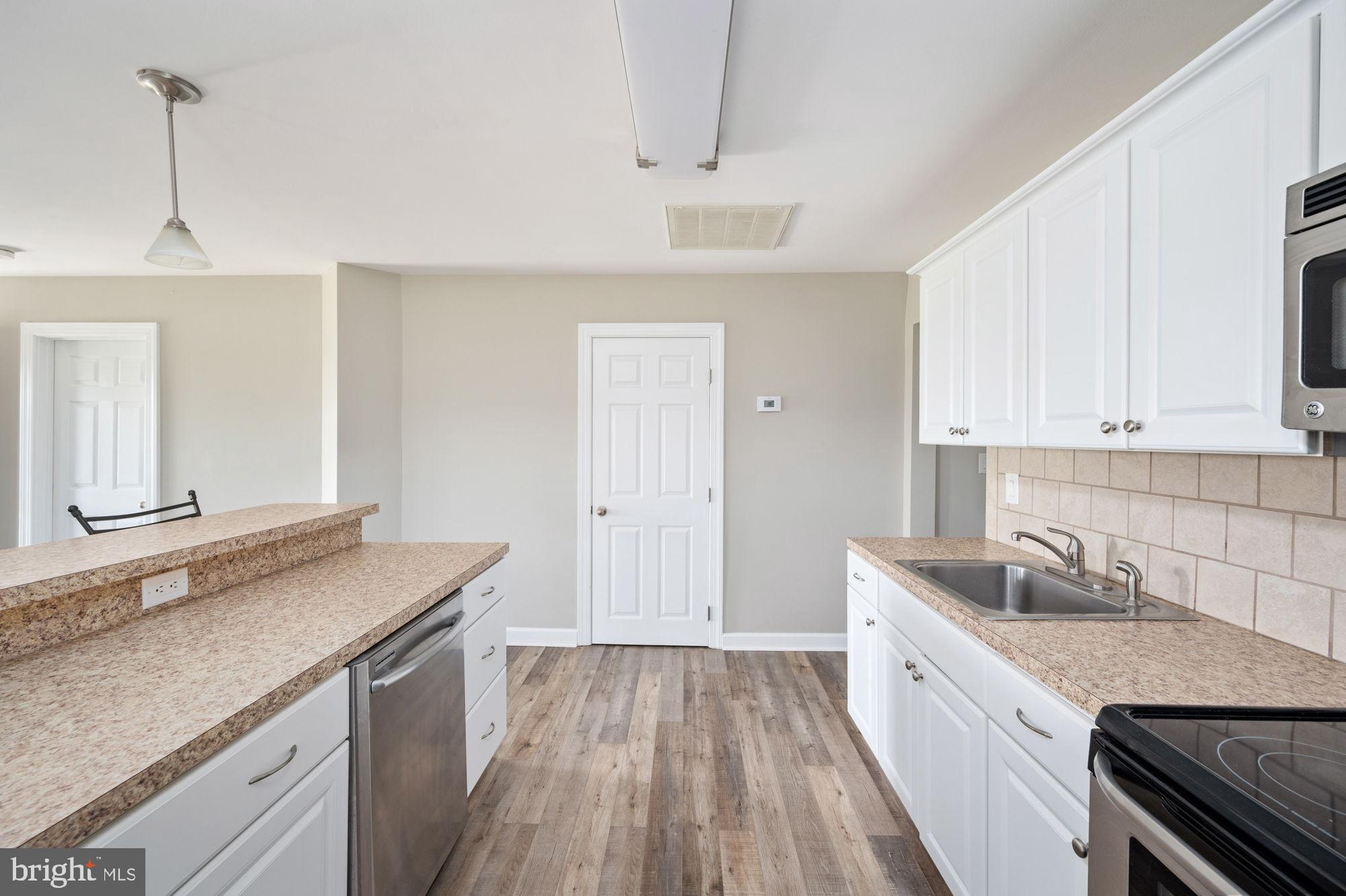 161 Forest Lane Road Fredericksburg, VA 22405 - Photo 27 of 99 a kitchen with granite countertop a sink stove and cabinets