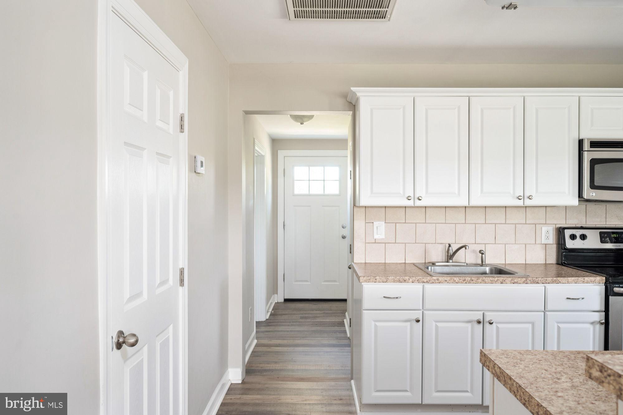161 Forest Lane Road Fredericksburg, VA 22405 - Photo 29 of 99 a kitchen with white cabinets and sink