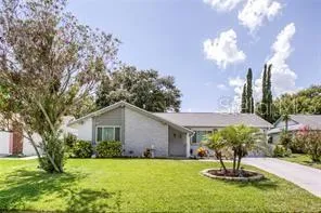 a view of a house with a yard and a fountain
