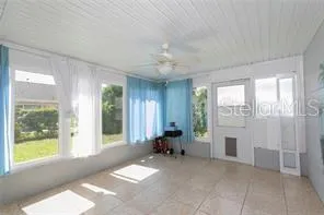 a living room with furniture and large windows