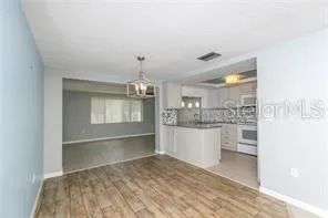 a room with kitchen island and stainless steel appliances