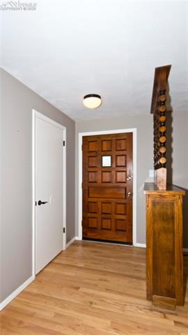 4027 Maxwell Road Colorado Springs, CO 80909 - Photo 6 of 35 Front foyer with lovely front door and a coat closet right off entrance.