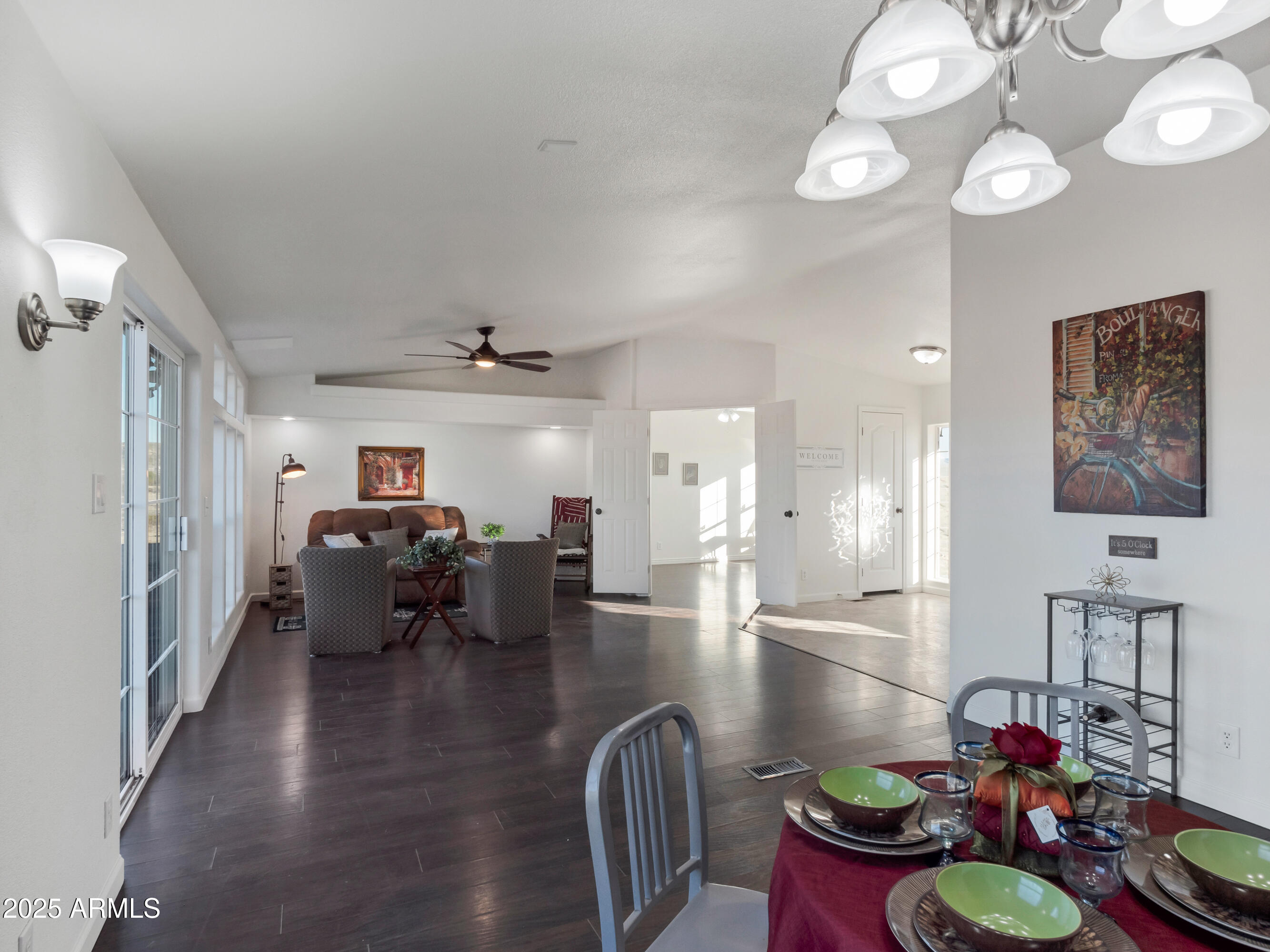 2164 East Liberty Trail Rimrock, AZ 86335 - Photo 13 of 36 a view of a dining room with furniture a chandelier and wooden floor