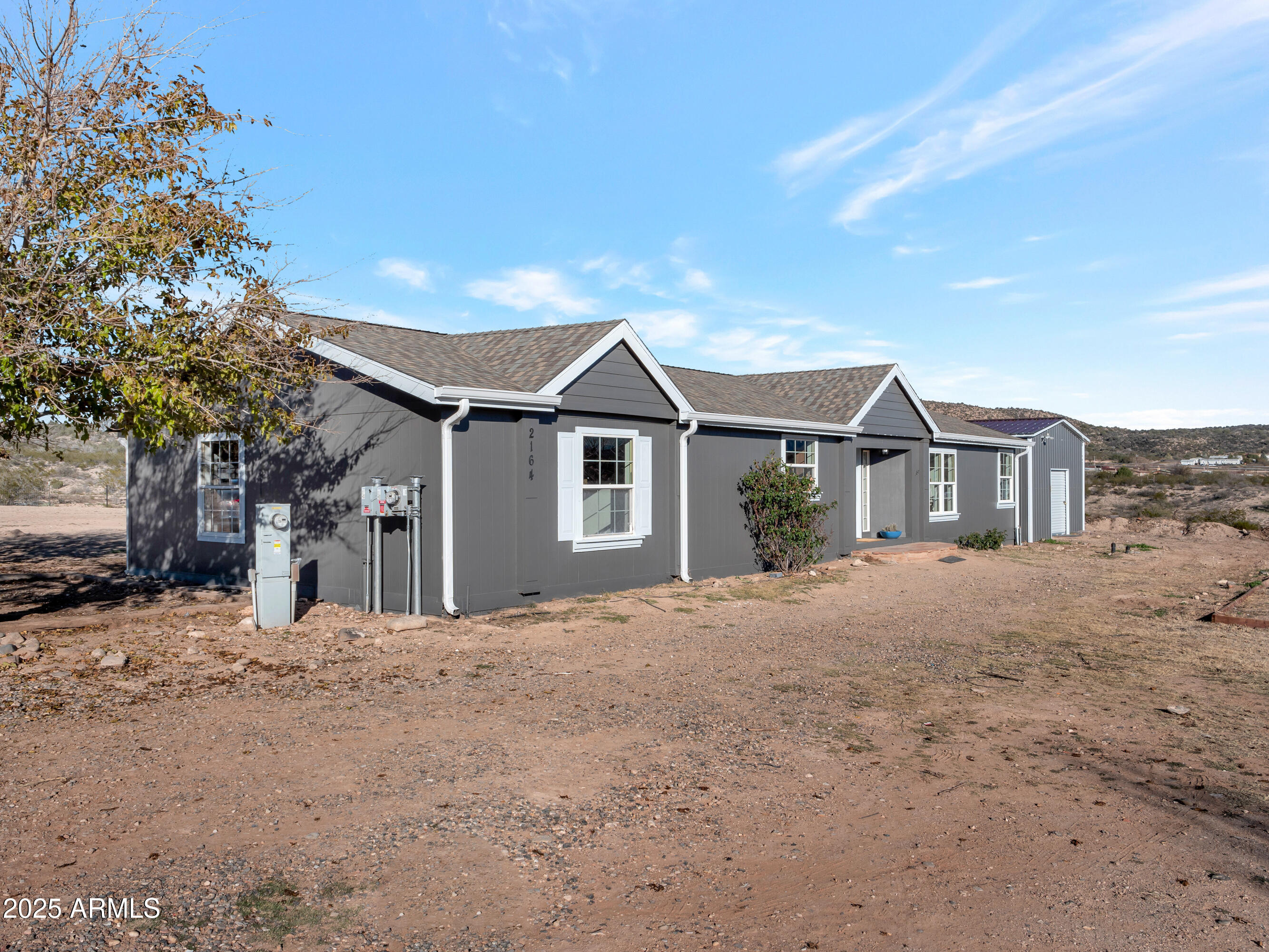 2164 East Liberty Trail Rimrock, AZ 86335 - Photo 2 of 36 a front view of a house with a yard and garage