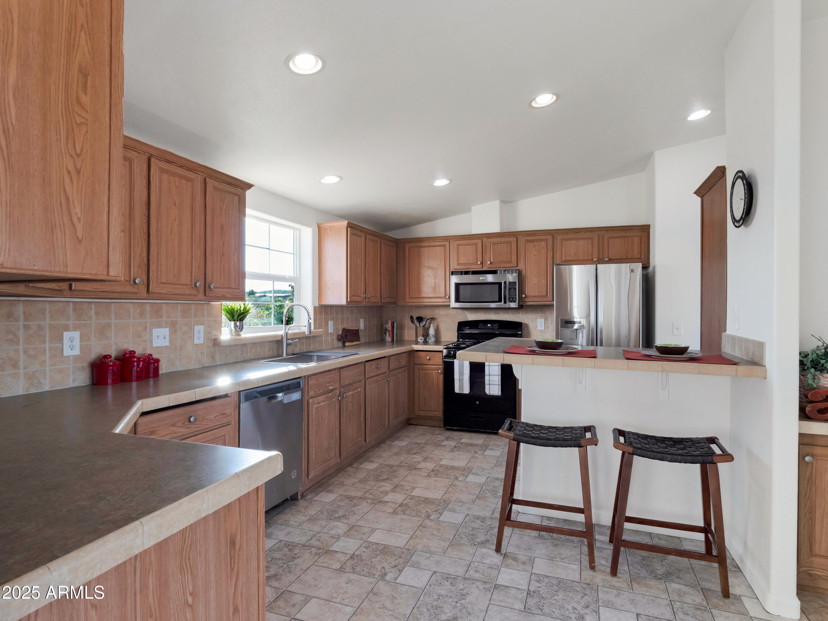 2164 East Liberty Trail Rimrock, AZ 86335 - Photo 6 of 36 a kitchen with stainless steel appliances granite countertop a sink counter space cabinets and a stove