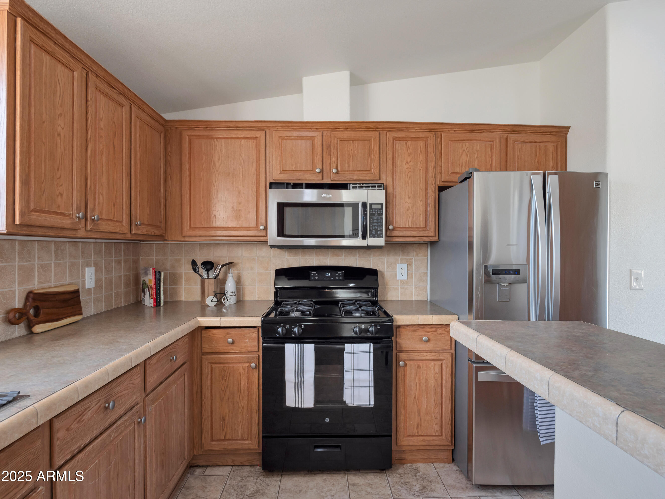 2164 East Liberty Trail Rimrock, AZ 86335 - Photo 10 of 36 a kitchen with granite countertop white cabinets and stainless steel appliances