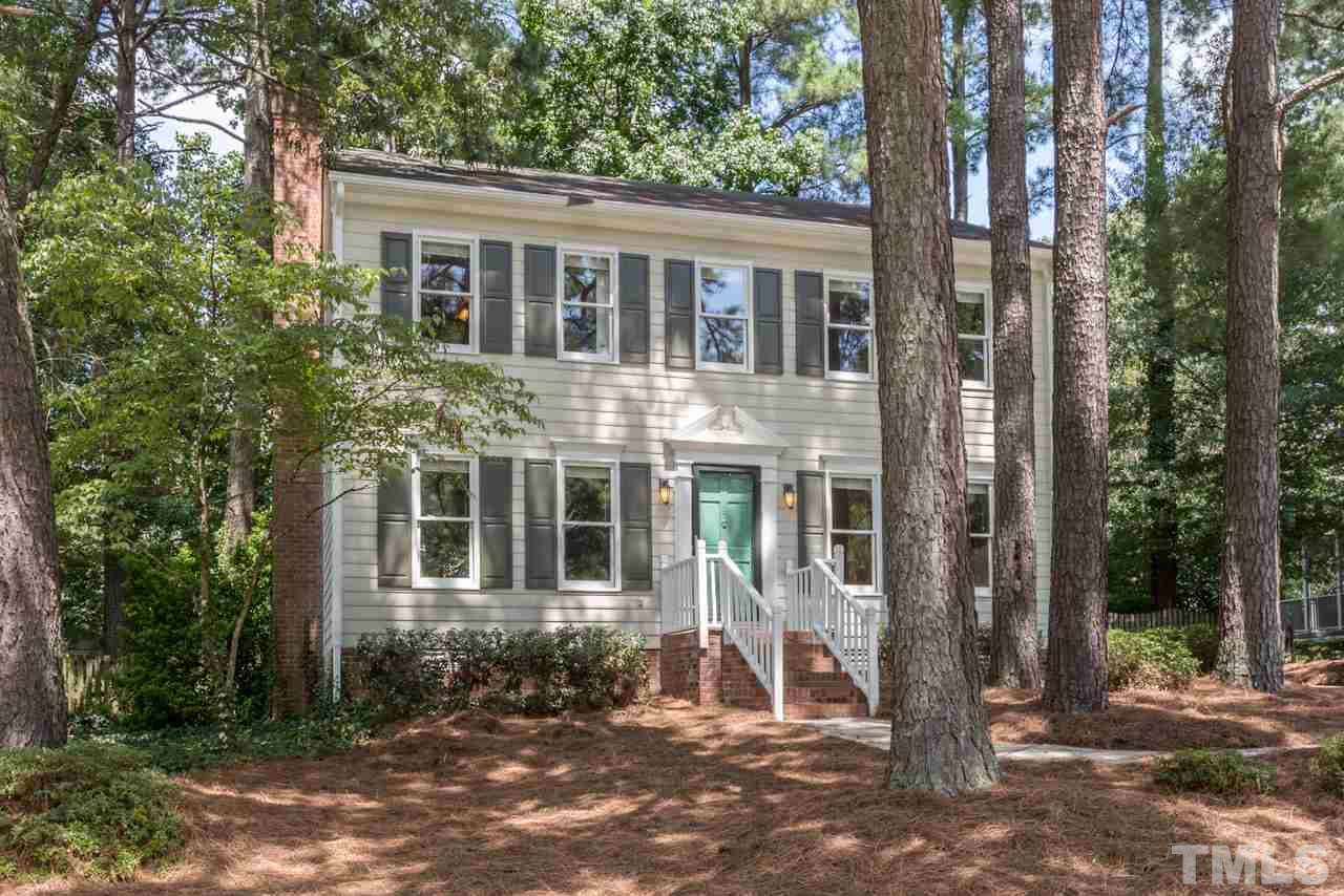 7308 Wilderness Road Raleigh, NC 27613 - Photo 1 of 25 a front view of a house with a yard