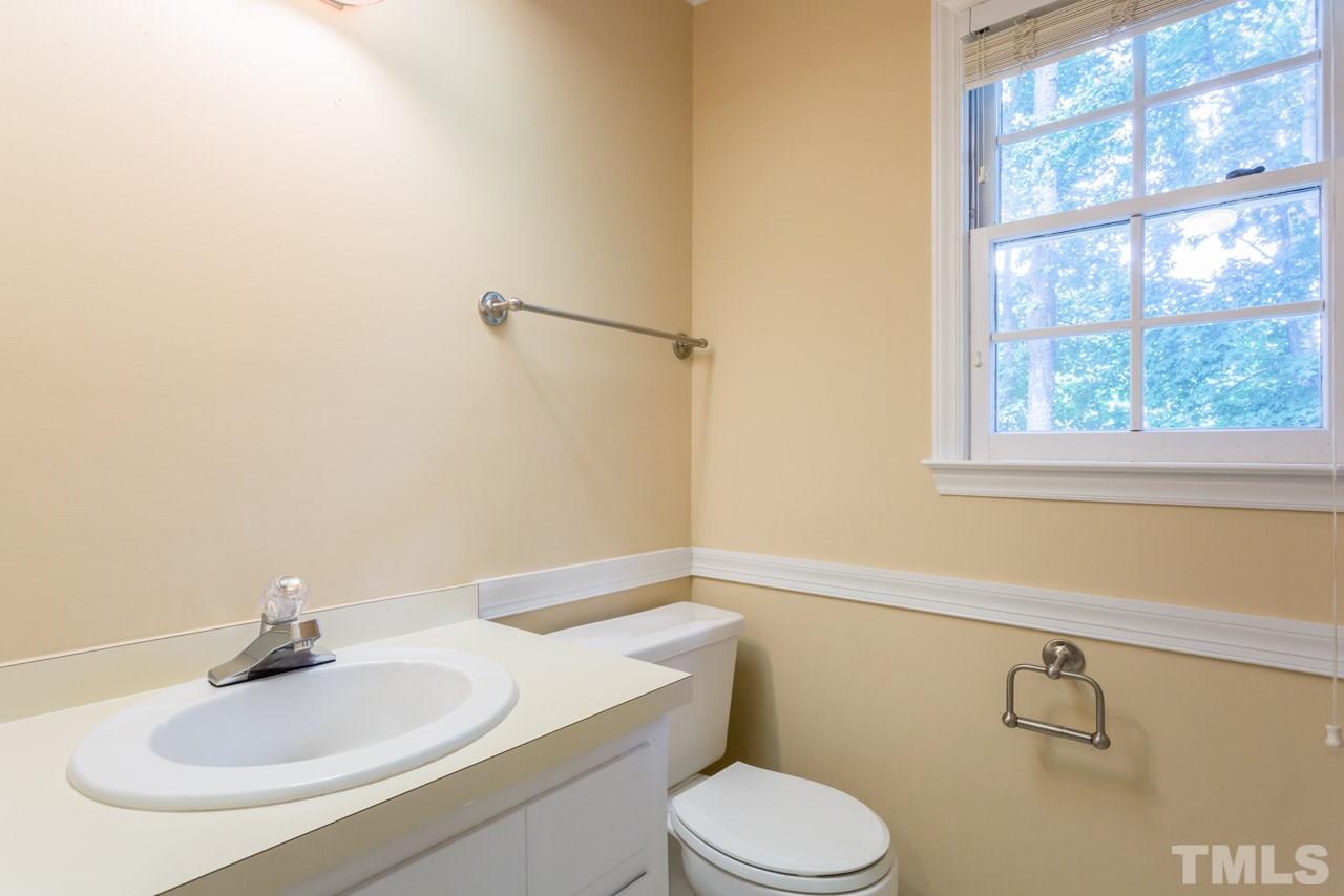 7308 Wilderness Road Raleigh, NC 27613 - Photo 15 of 25 a bathroom with a sink toilet and a mirror