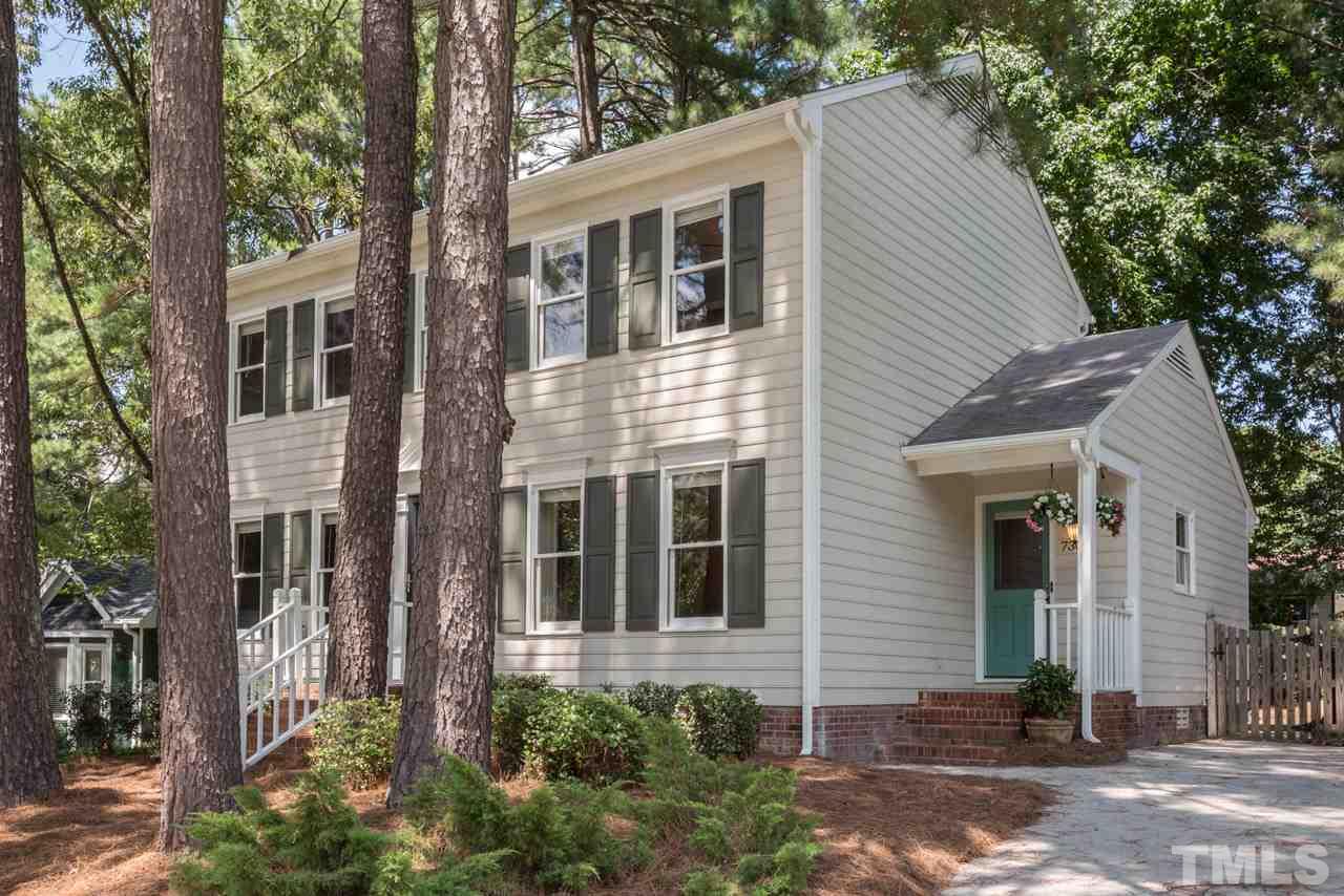 7308 Wilderness Road Raleigh, NC 27613 - Photo 19 of 25 a view of a house with a yard and potted plants