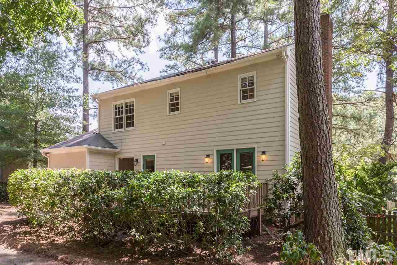 7308 Wilderness Road Raleigh, NC 27613 - Photo 20 of 25 a view of a house with a yard