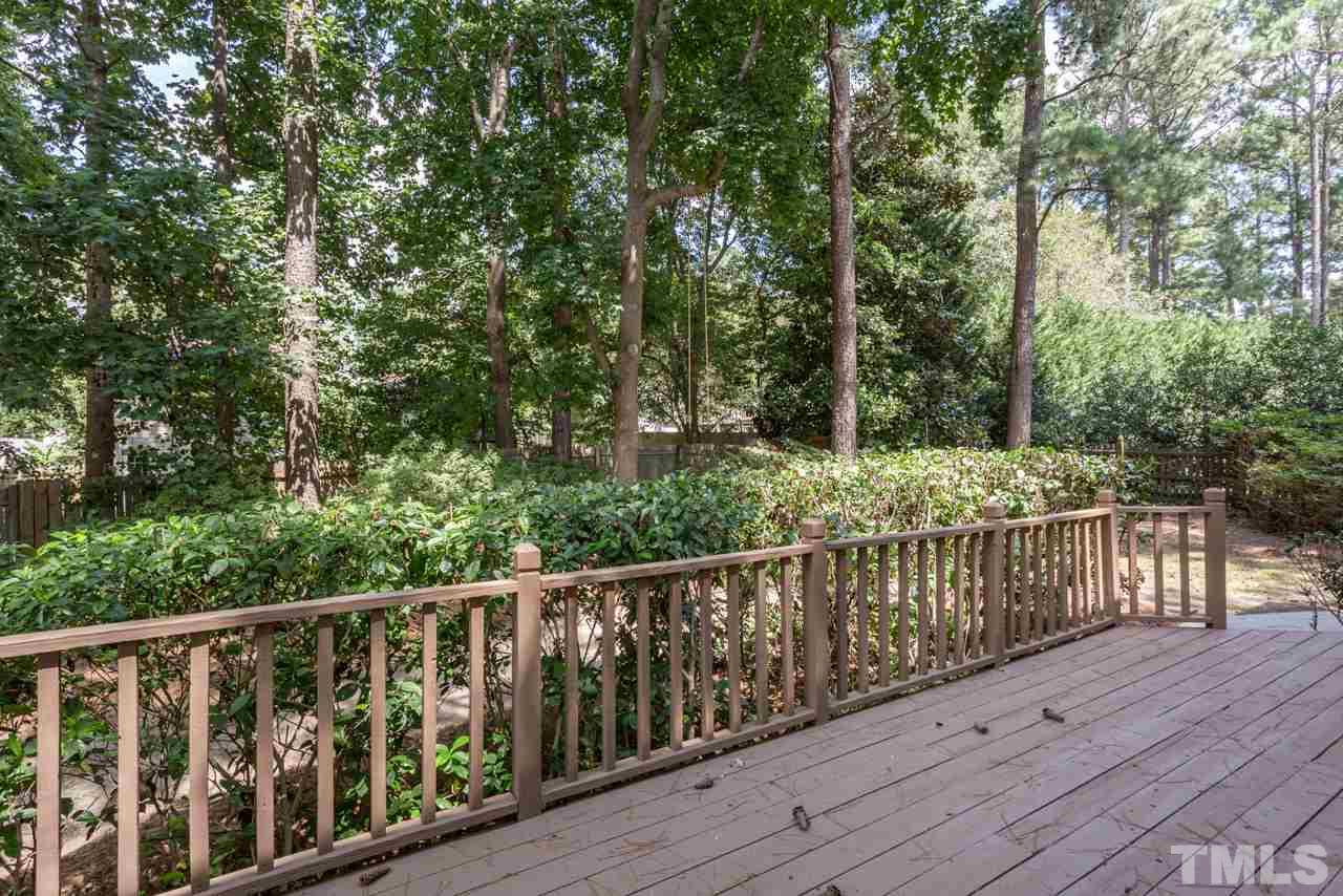 7308 Wilderness Road Raleigh, NC 27613 - Photo 22 of 25 a view of a wooden deck with trees