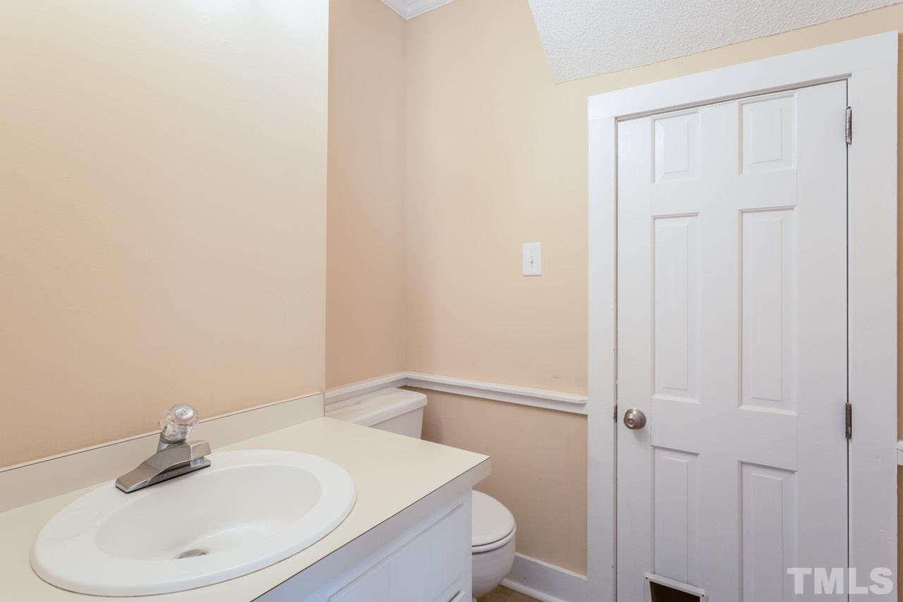 7308 Wilderness Road Raleigh, NC 27613 - Photo 9 of 25 a bathroom with a sink a toilet and shower
