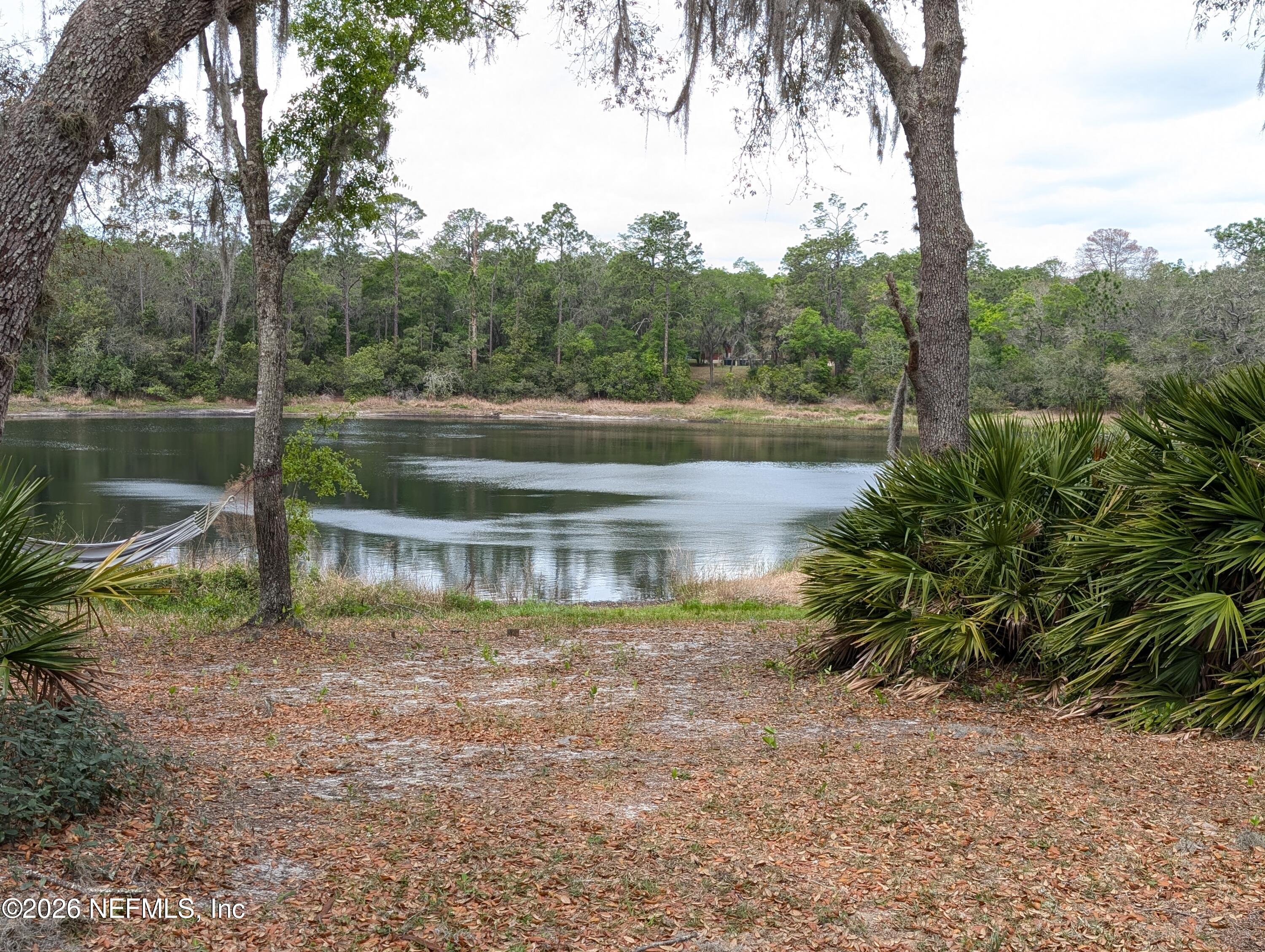 125 Hayman Drive Interlachen, FL 32148 - Photo 13 of 14 a view of a lake with a yard and large trees