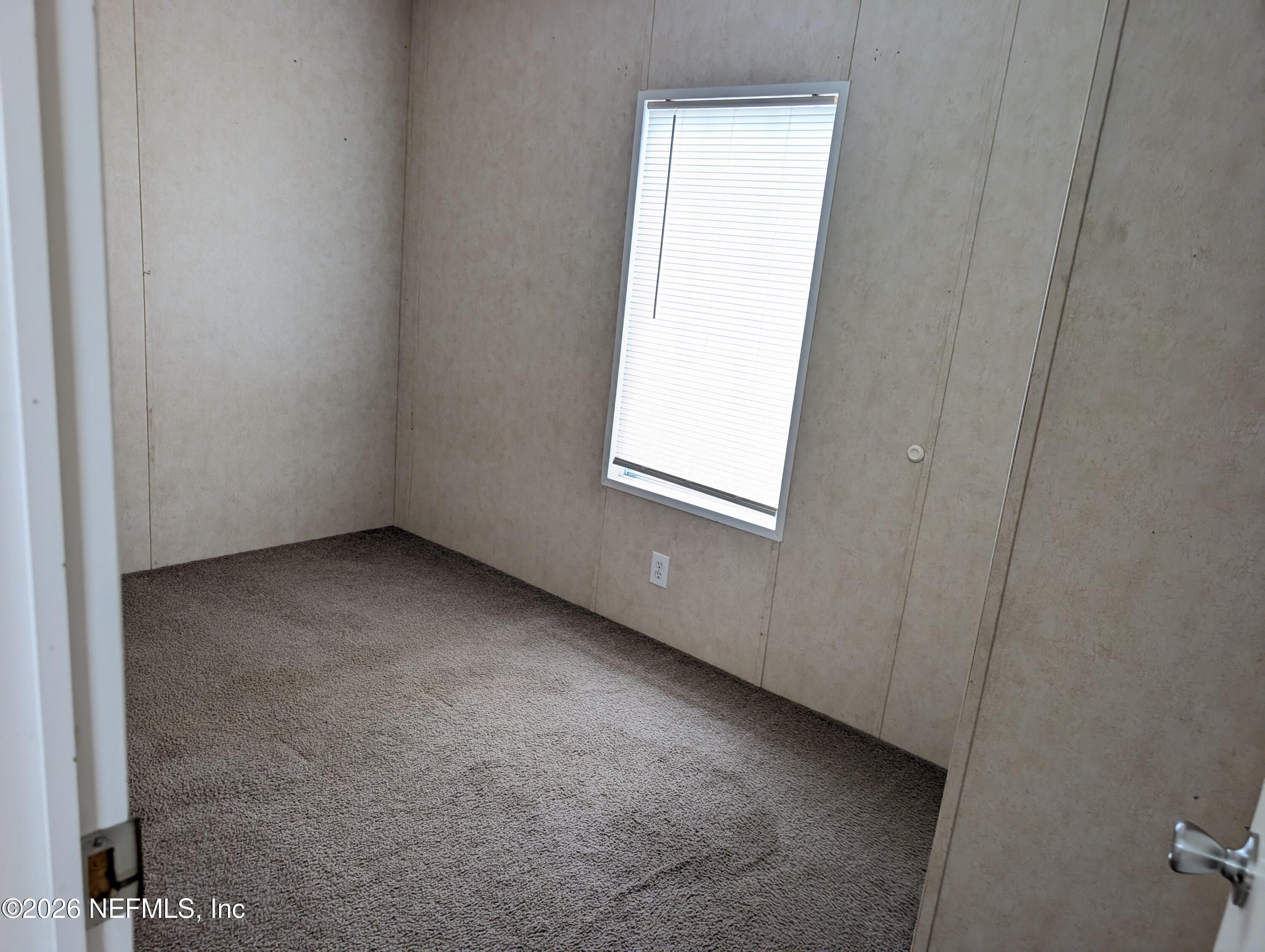 125 Hayman Drive Interlachen, FL 32148 - Photo 5 of 14 an empty room with a window