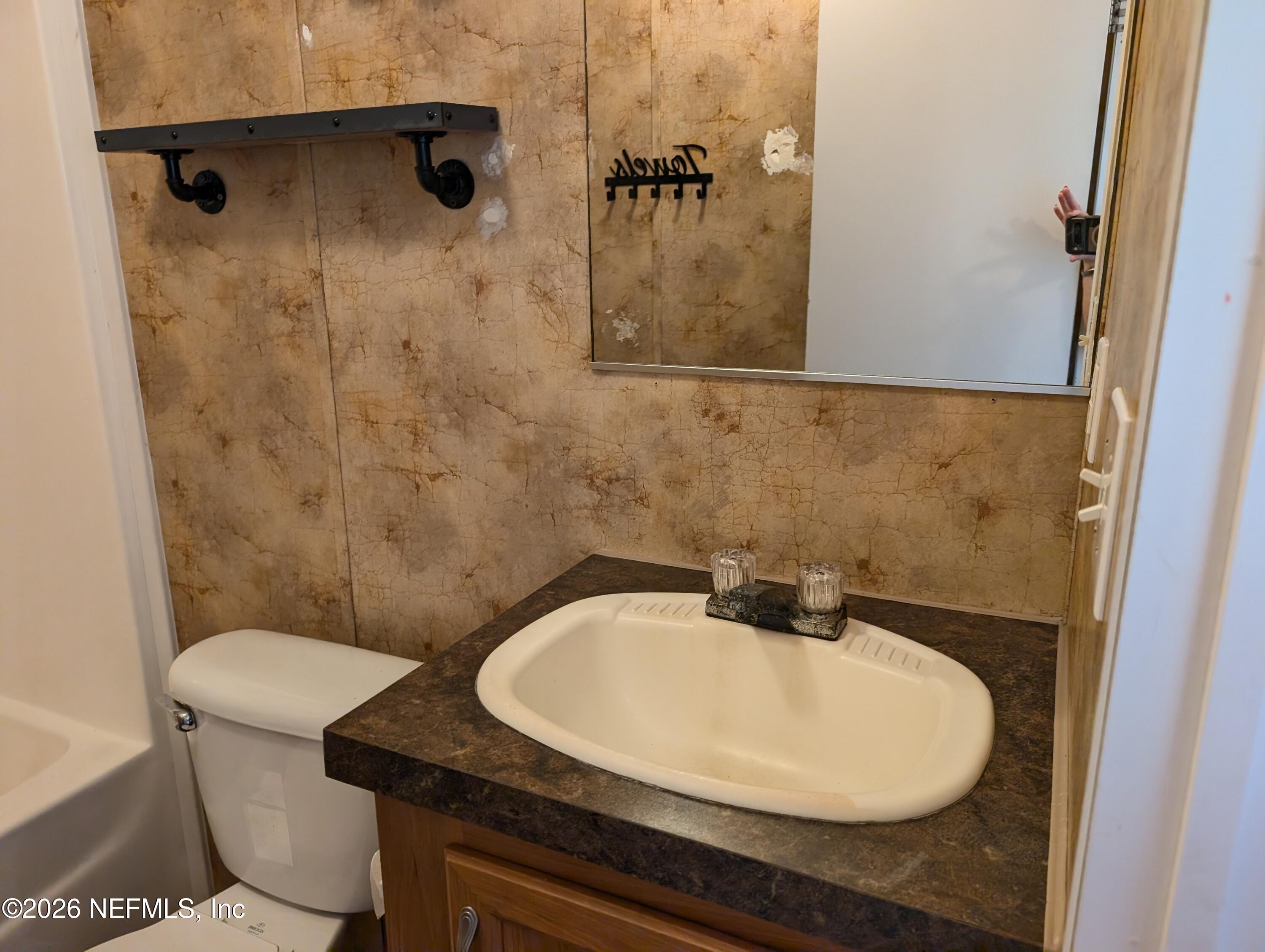 125 Hayman Drive Interlachen, FL 32148 - Photo 9 of 14 a bathroom with a sink a toilet and shower