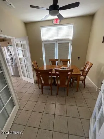 a living room with furniture and a gym machine
