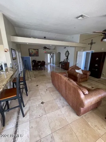 a bedroom with two beds and a ceiling fan