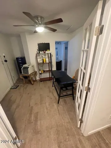 a spacious bedroom with a bed and a chandelier