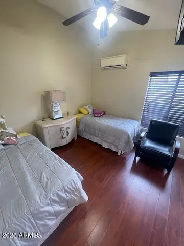 a bedroom with a large bed and a chandelier